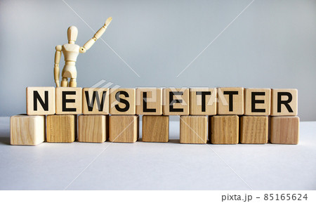 'Newsletter' written on wood blocks. Wooden mannequin, model of human. Business concept. Copy space. Beautiful white background. 85165624