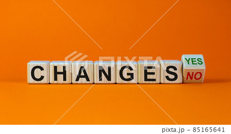 Turned a cube and changed the expression 'changes no' to 'changes yes'. Beautiful orange background. Copy space. Turned a cube and changed the expression 'changes no' to 'changes yes'. Beautiful orange background. Copy space. 85165641