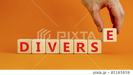 Diverse and diversity symbol. The concept word Diverse on wooden cubes. Beautiful orange table, orange background, copy space. Businessman hand. Business diversity and diverse concept. Diverse and diversity symbol. The concept word Diverse on wooden cubes. Beautiful orange table, orange background, copy space. Businessman hand. Business diversity and diverse concept. 85165659