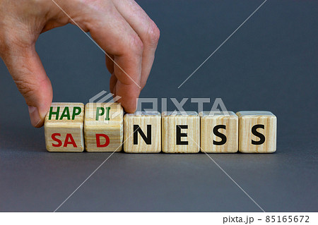 Happiness or sadness symbol. Businessman turns cubes and changes the word 'sadness' to 'happiness'. Beautiful grey background. Business, psychological and happines or sadness concept. Copy space. 85165672