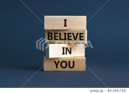 I believe in you symbol. Concept words 'I believe in you' on wooden blocks on a beautiful grey background. Businessman hand. Business, religion and i believe in you concept. 85165730