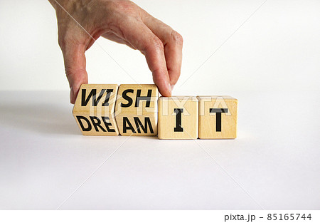 Dream and wish it symbol. Businessman turns cubes and changes words 'dream it' to 'wish it'. Beautiful white table, white background. Business and dream and wish it concept. Copy space. Dream and wish it symbol. Businessman turns cubes and changes words 'dream it' to 'wish it'. Beautiful white table, white background. Business and dream and wish it concept. Copy space. 85165744