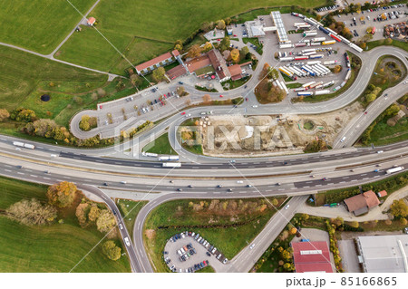 Top down aerial view of freeway interstate road with moving traffic cars in rural area. 85166865