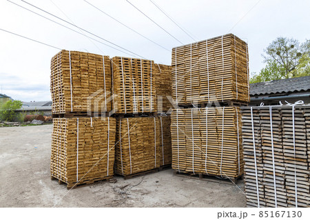 Stack of new wooden boards and studs at the lumber yard. Wooden plates on piles for furniture materials 85167130