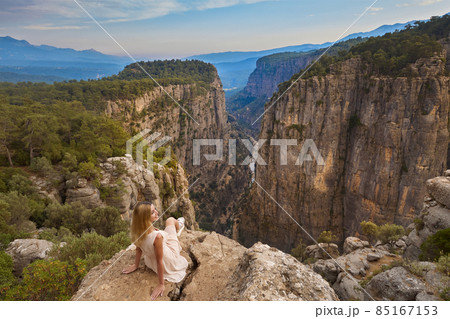Tourist woman on the edge of a cliff of Tazi Canyon in Manavgat, Antalya, Turkey. Greyhound Canyon, Wisdom Valley. 85167153