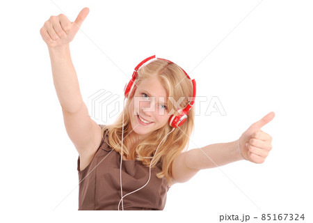 Pretty teenage girl listening music on her headphones Pretty teenage girl listening music on her headphones 85167324