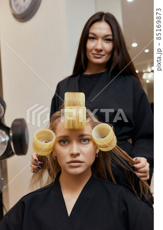 Drying blond hair with hair dryer and round brush. Drying blond hair with hair dryer and round brush. 85169873