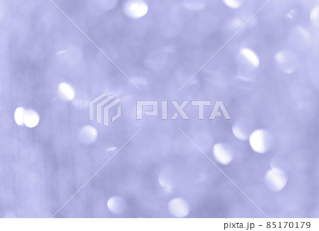 Abstract bokeh background. Light violet blue wallpaper. Color of the year 2022. Bright blurred shimmering garland. Soft focuse 85170179