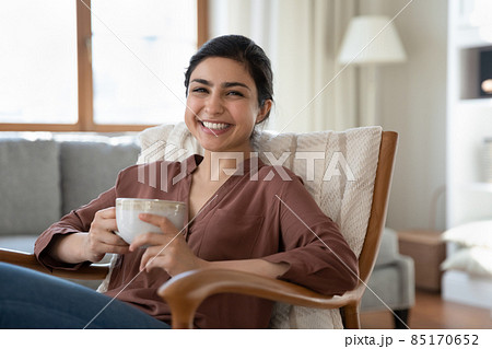 Portrait of smiling indian woman with cup of tea. Portrait of smiling indian woman with cup of tea. 85170652