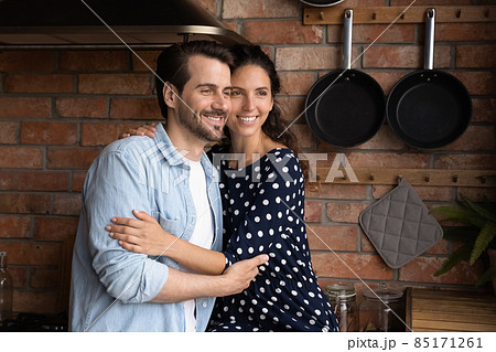 Dreamy loving millennial couple visualizing future at home. Dreamy loving millennial couple visualizing future at home. 85171261