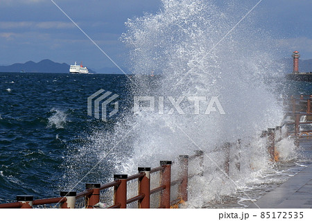 強風波浪、瀬戸内海に荒波が発生上がる大きな波しぶき、かすむ赤灯台 強風波浪、瀬戸内海に荒波が発生上がる大きな波しぶき、かすむ赤灯台 85172535