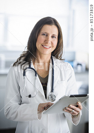 Caucasian doctor using tablet computer in office 85173819