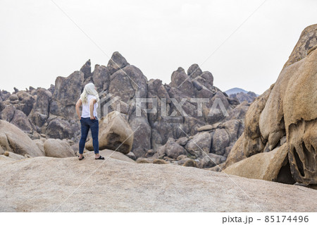 USA, California, Lone Pine, Woman looking at Alabama Hills in Sierra Nevada Mountains USA, California, Lone Pine, Woman looking at Alabama Hills in Sierra Nevada Mountains 85174496