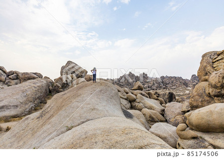 USA, California, Lone Pine, Woman looking at Alabama Hills in Sierra Nevada Mountains USA, California, Lone Pine, Woman looking at Alabama Hills in Sierra Nevada Mountains 85174506