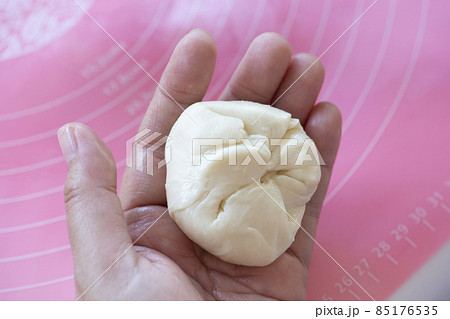 Closed up photo of dough on woman hands. Closed up photo of dough on woman hands. 85176535