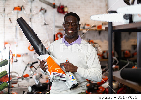 African-american man with leaf blower in gardening tools shop 85177055