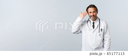 Covid-19, coronavirus outbreak, healthcare workers and pandemic concept. Skeptical bothered male doctor scolding person for being irresponsible, pointing at head, someone acting stupid 85177115