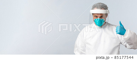 Covid-19, preventing virus, healthcare workers and vaccination concept. Confident doctor working with coronavirus patients in personal protective equipment, show thumb-up, assure all be alright Covid-19, preventing virus, healthcare workers and vaccination concept. Confident doctor working with coronavirus patients in personal protective equipment, show thumb-up, assure all be alright 85177544