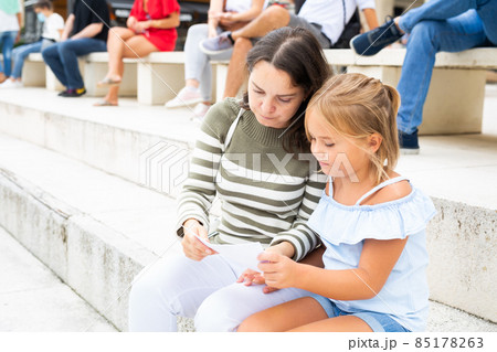 Mother and daughter looking at sight during sightseeing tour 85178263