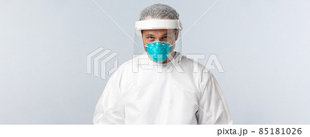 Covid-19, preventing virus, healthcare workers and vaccination concept. Serious doctor in personal protective equipment and medical respirator entering hospital ward with coronavirus sick patients Covid-19, preventing virus, healthcare workers and vaccination concept. Serious doctor in personal protective equipment and medical respirator entering hospital ward with coronavirus sick patients 85181026