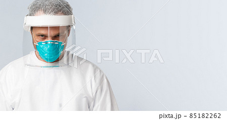 Covid-19, preventing virus, healthcare workers and vaccination concept. Close-up of determined serious doctor in personal protective equipment, medical respirator, working with dangerious diseases 85182262