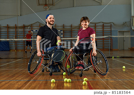 pair of disabled tennis players hugging each other pair of disabled tennis players hugging each other 85183564