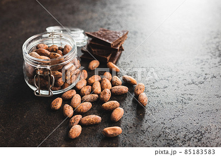 Dried cocoa beans. Cacao beans in jar. Dried cocoa beans. Cacao beans in jar. 85183583