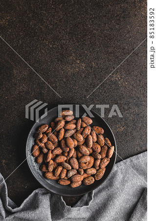 Dried cocoa beans. Cacao beans on plate. Dried cocoa beans. Cacao beans on plate. 85183592