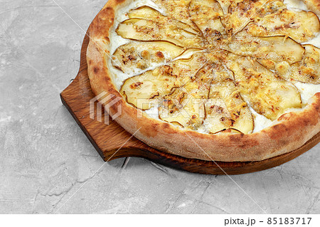 Pizza with pear, gorgonzola and on stone background. Top view. 85183717