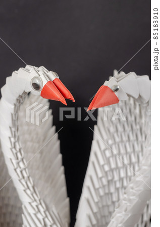 Close-up of a pair of white paper swans. A symbol of love and fi Close-up of a pair of white paper swans. A symbol of love and fi 85183910