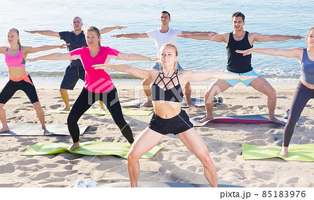 People doing exercises on beach People doing exercises on beach 85183976