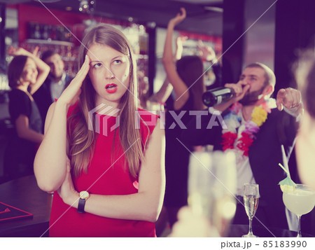 Offended woman with drunk man on party at nightclub 85183990