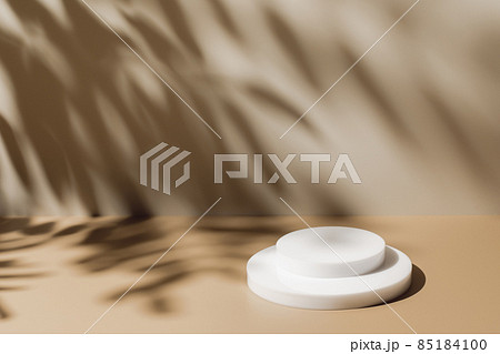 scene with white podium on beige background and shadows 85184100