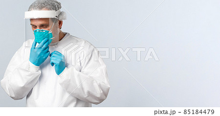 Covid-19, preventing virus, healthcare workers and vaccination concept. Tired doctor working in clinic with contaigned patients, sick coronavirus, fixing medical respirator while wearing PPE Covid-19, preventing virus, healthcare workers and vaccination concept. Tired doctor working in clinic with contaigned patients, sick coronavirus, fixing medical respirator while wearing PPE 85184479
