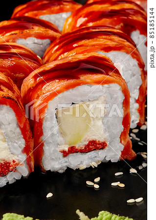 Closeup of Philadelphia rolls with seared salmon, cream cheese, tobiko, apple, unagi sauce and sesame Closeup of Philadelphia rolls with seared salmon, cream cheese, tobiko, apple, unagi sauce and sesame 85185144