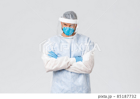 Covid-19 pandemic, virus outbreak, clinic and healthcare workers concept. Confident doctor in personal protective equipment determined fight coronavirus, cure sick patients 85187732