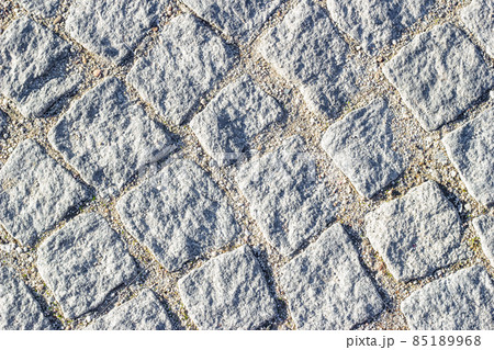 Background texture of masonry with sand in seams between paving stones. Circular lines, top view. 85189968