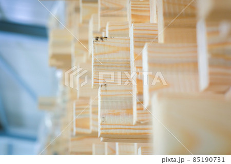A large pile of wooden boards stored in a sawmill. Selective focus 85190731