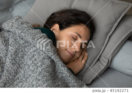 Carefree latina female sleep on couch put hands under cheek Carefree latina female sleep on couch put hands under cheek 85192271
