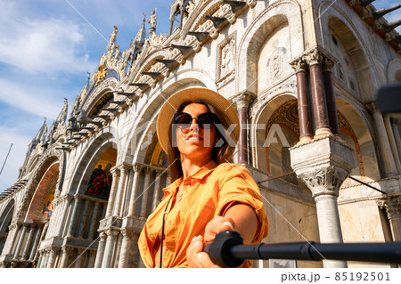 Travel influencers Venice island. Paint building house in Europe Venezia city. Photographer blogger girl with smartphone in Venice San Marco square. Traveling and freelancing, modern lifestyle. Travel influencers Venice island. Paint building house in Europe Venezia city. Photographer blogger girl with smartphone in Venice San Marco square. Traveling and freelancing, modern lifestyle. 85192501