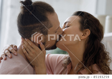 Sweet romantic couple in love kissing on lips at home 85193259