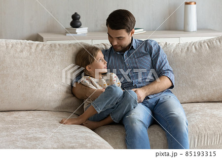 Affectionate millennial single father talking with kid daughter. Affectionate millennial single father talking with kid daughter. 85193315