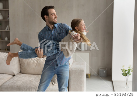 Happy millennial caring father playing with small daughter. 85193729