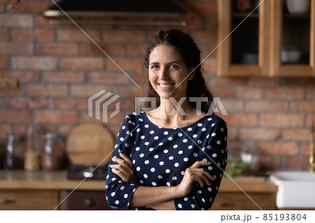 Portrait of smiling millennial hispanic woman posing indoors. 85193804
