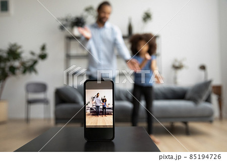 Happy African American family recording video on cellphone web camera. 85194726