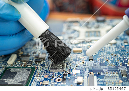 Technician use brush and air blower ball to clean dust in circuit board computer. Repair upgrade and maintenance technology. Technician use brush and air blower ball to clean dust in circuit board computer. Repair upgrade and maintenance technology. 85195467