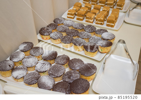 Catering. Off-site food. Buffet table with various canapes, sandwiches, hamburgers and snacks. Catering. Off-site food. Buffet table with various canapes, sandwiches, hamburgers and snacks. 85195520