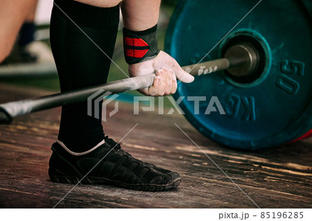 close-up athlete and barbell exercise deadlift 85196285