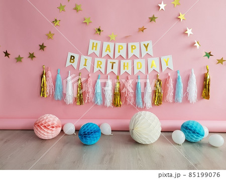 The pink decor of the birthday for girl with paper balloons, garlands, pompoms. 85199076