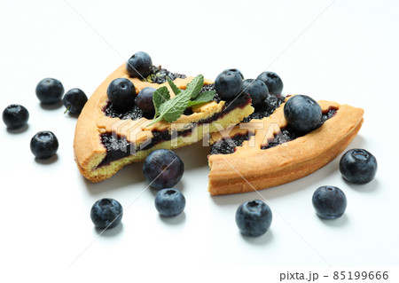 Pieces of blueberry pie with berries on white background 85199666
